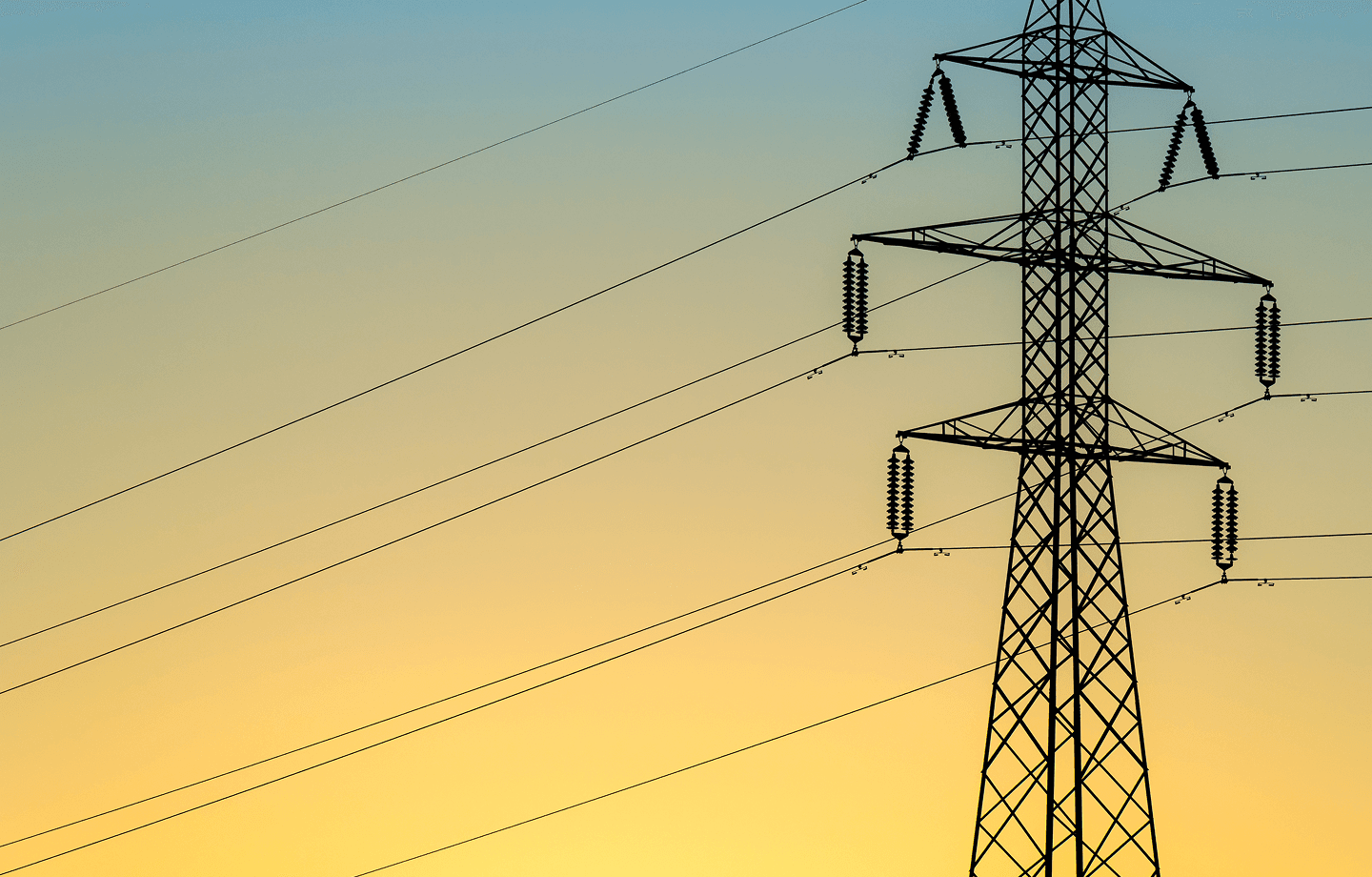 Electrical transmission tower against gradient sky